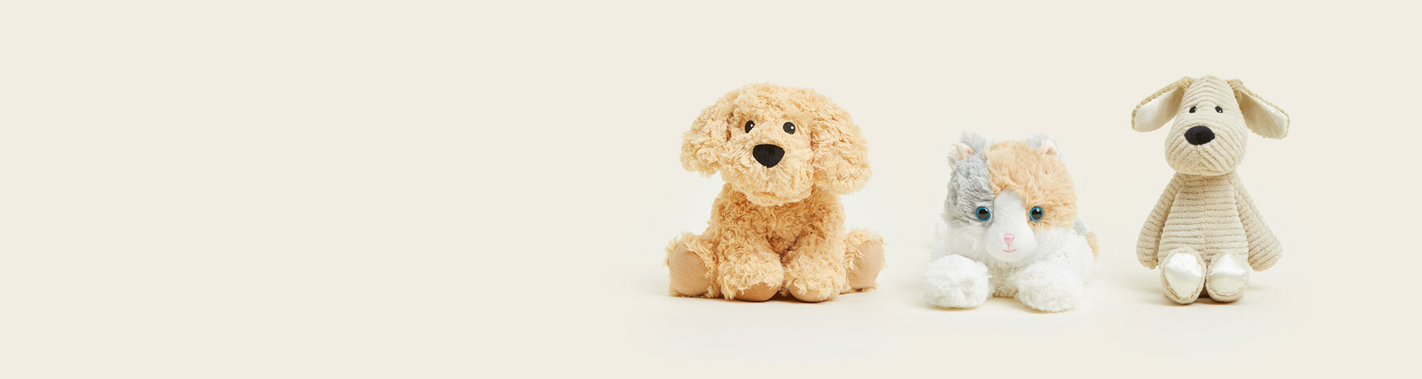 Golden Dog Warmies, Calico Cat Warmies and My First Puppy Warmies sitting in a row