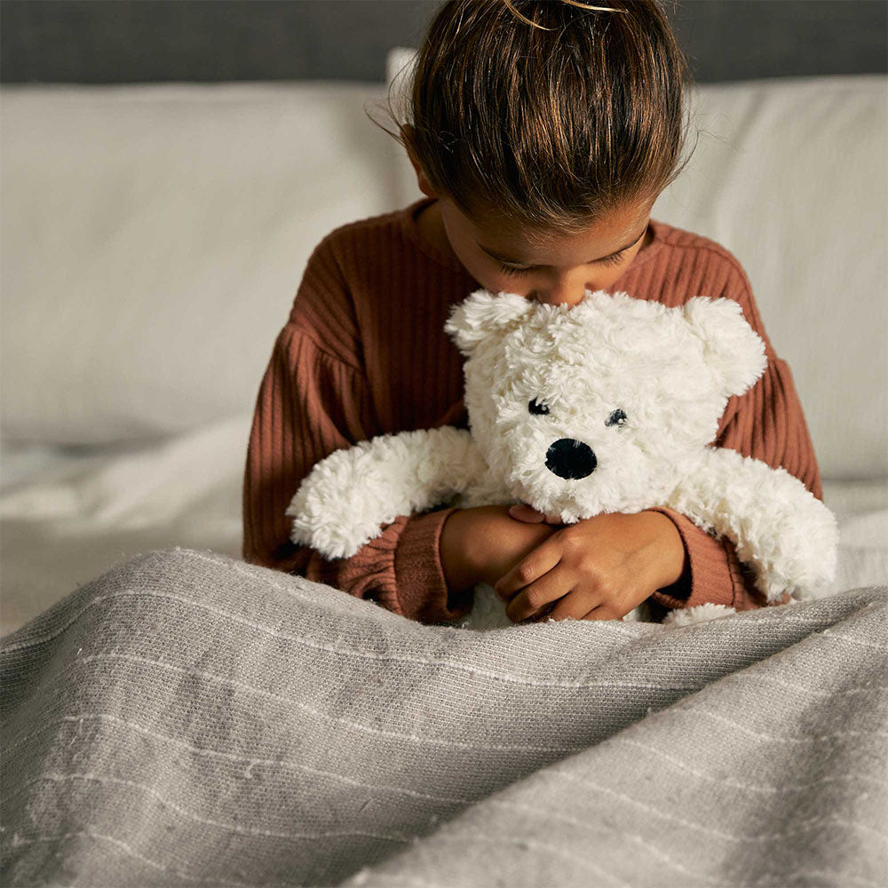 girl hugging teddy bear stuffed animal warmies
