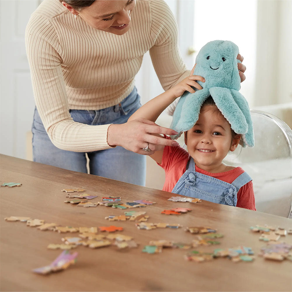 mom and child playing with octopus stuffed animal warmies
