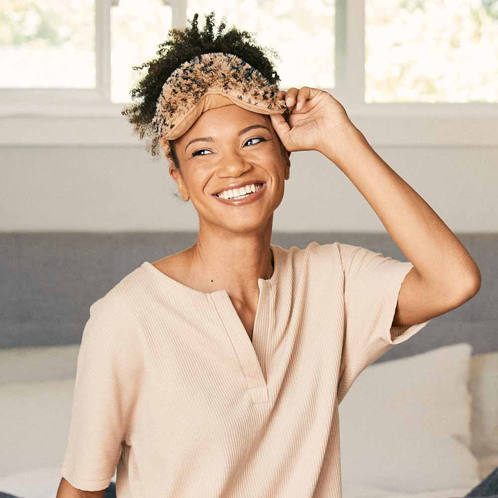 woman wearing leopard print warmies eye mask