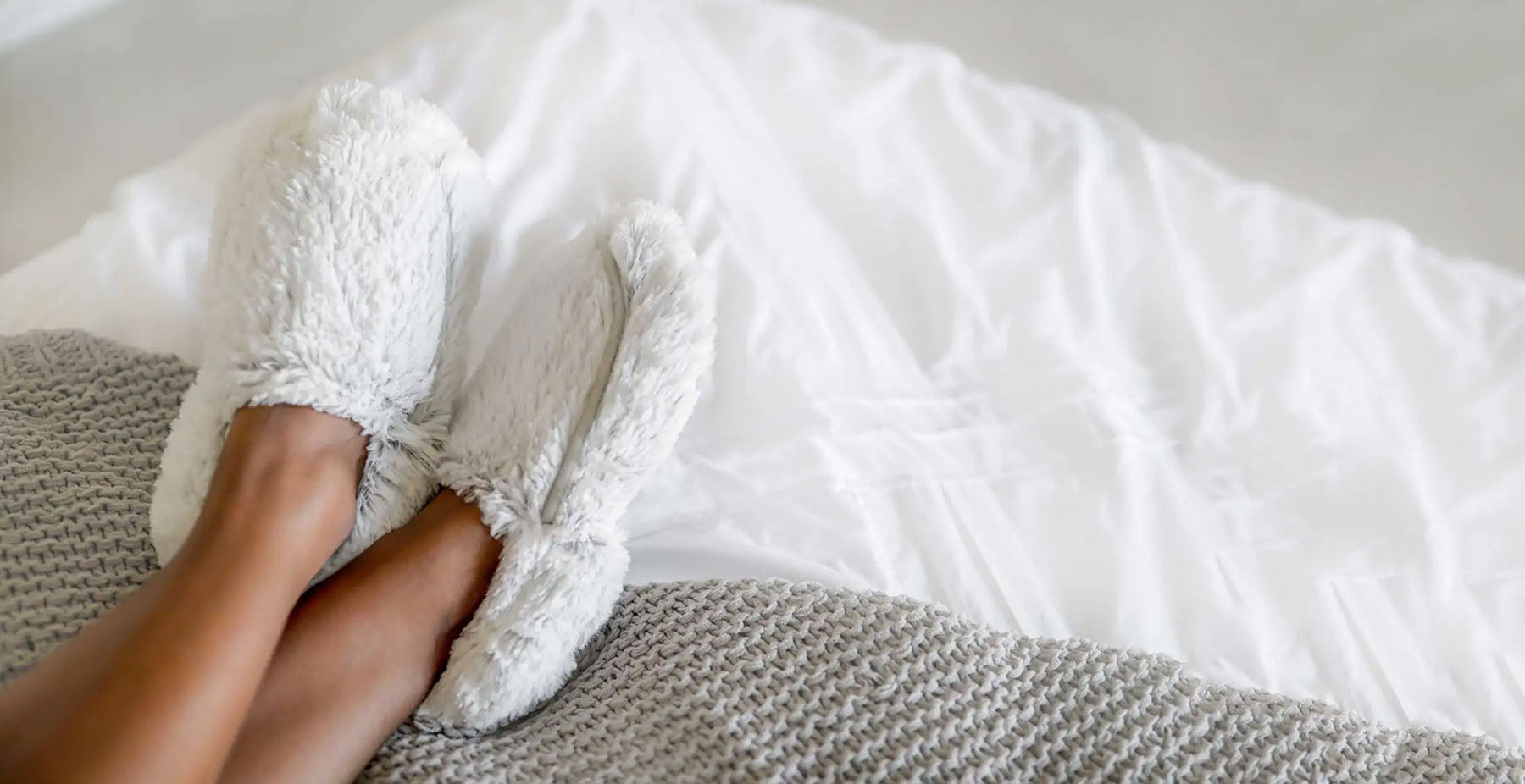 woman wearing warmies slippers for wellness