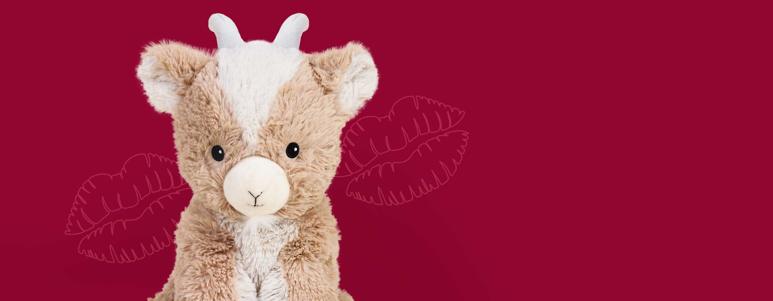 Goat Warmies microwaveable plush with kiss marks on a red background