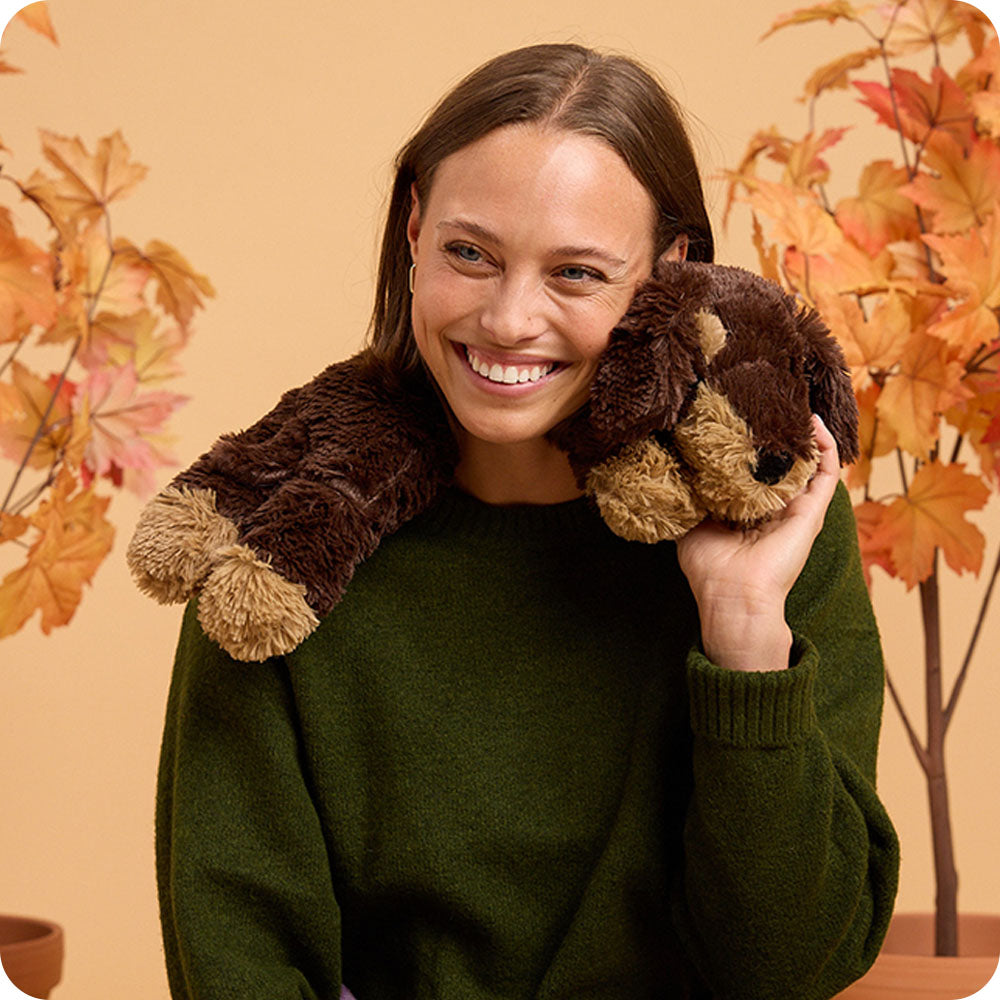 woman with a Dachshund wrap stuffed animal on her shoulders