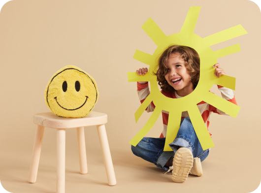 Child playing with Warmies Smiley Face.