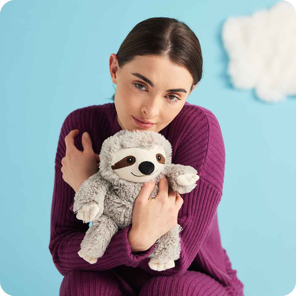Girl hugging Cute Weighted Lavender Scented Gray Sloth Stuffed Animal Heating Pad Warmies
