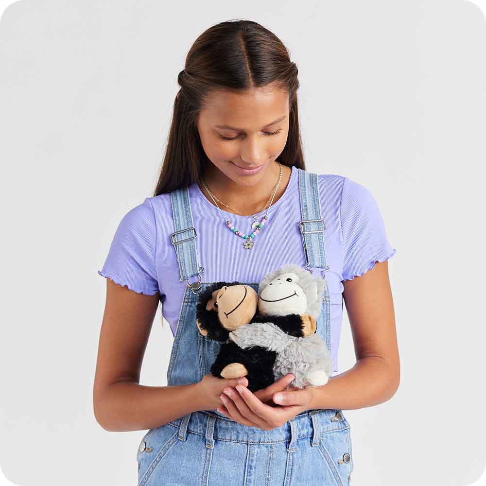 Teenager holding Soft Warm Weighted Lavender Scented Monkey Hugs Plush Warmies