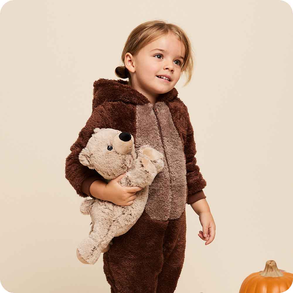 Child holding a Soft Warm Weighted Brown Bear Warmies