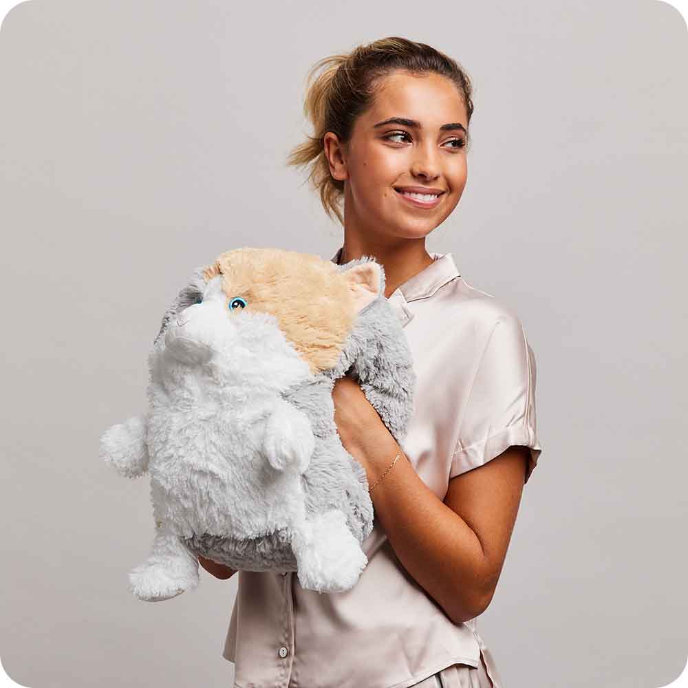 Woman standing and holding Soft Weighted Lavender Scented Supersized Cat Warmies