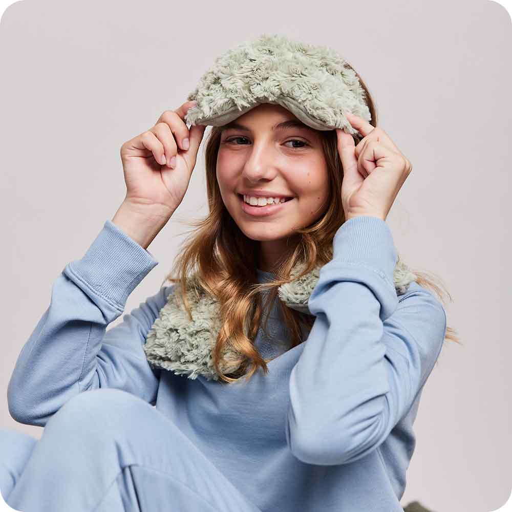 Teen wearing Microwavable Curly Sage Green Warmies Eye Mask - Warmies USA