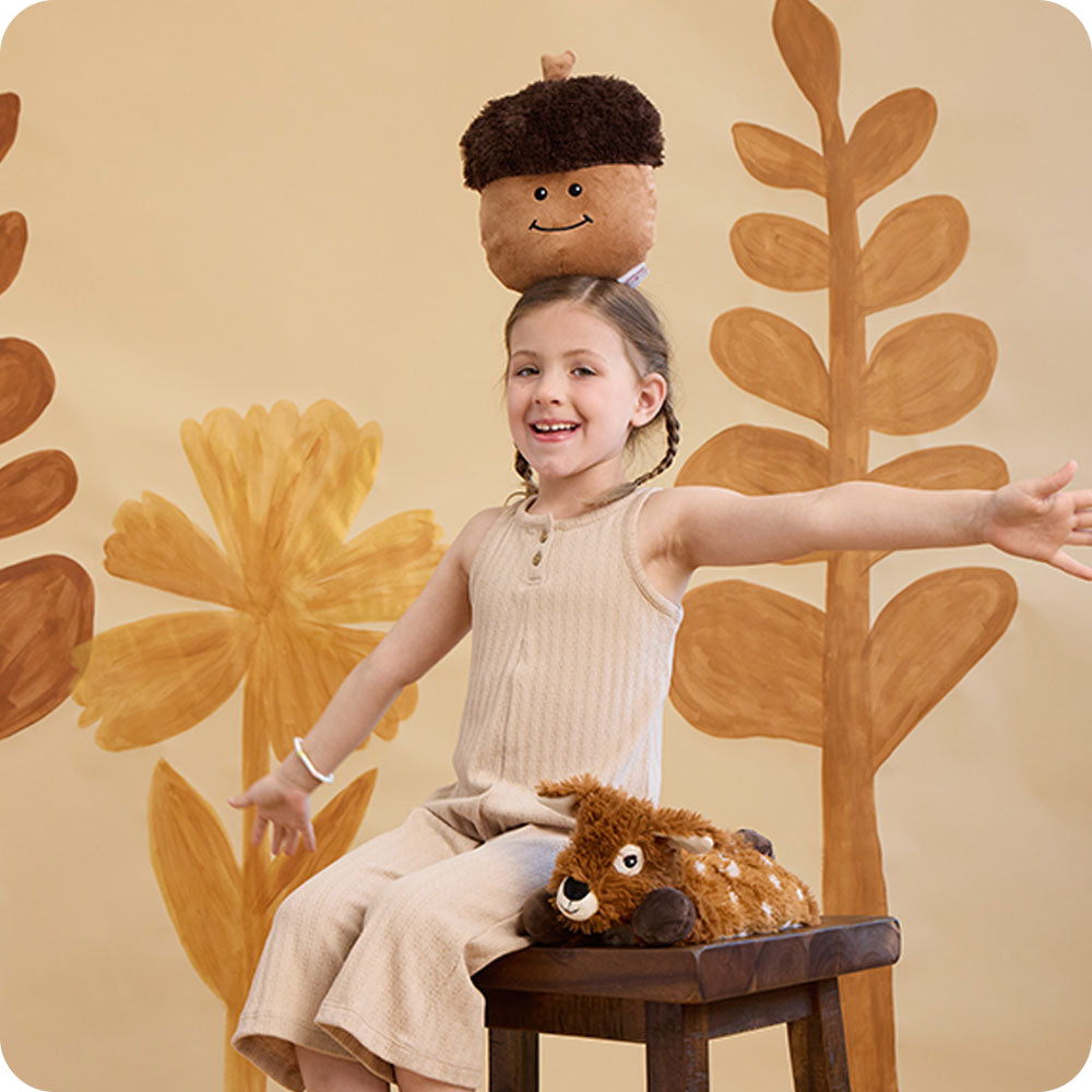 girl with acorn stuffed animal on her head