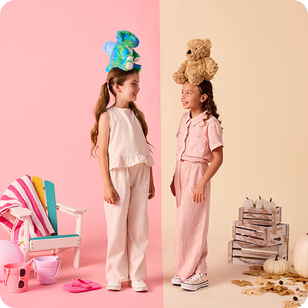 girl with a baby dragon stuffed animal on her head