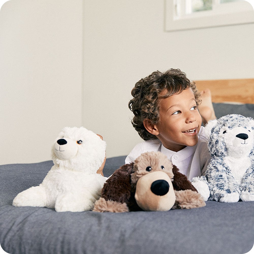 baby seal stuffed animal on boys bed