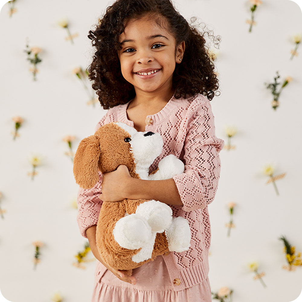 girl holding beagle stuffed animal lifestyle