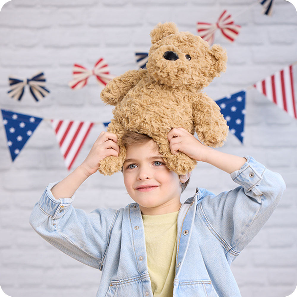 brown curly bear lifestyle stuffed animal on boys head