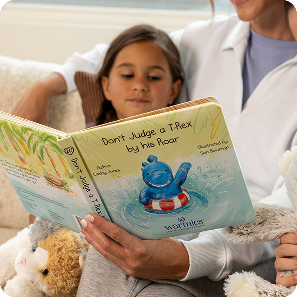 girl reading Don't Judge a TRex by his Roar warmies book