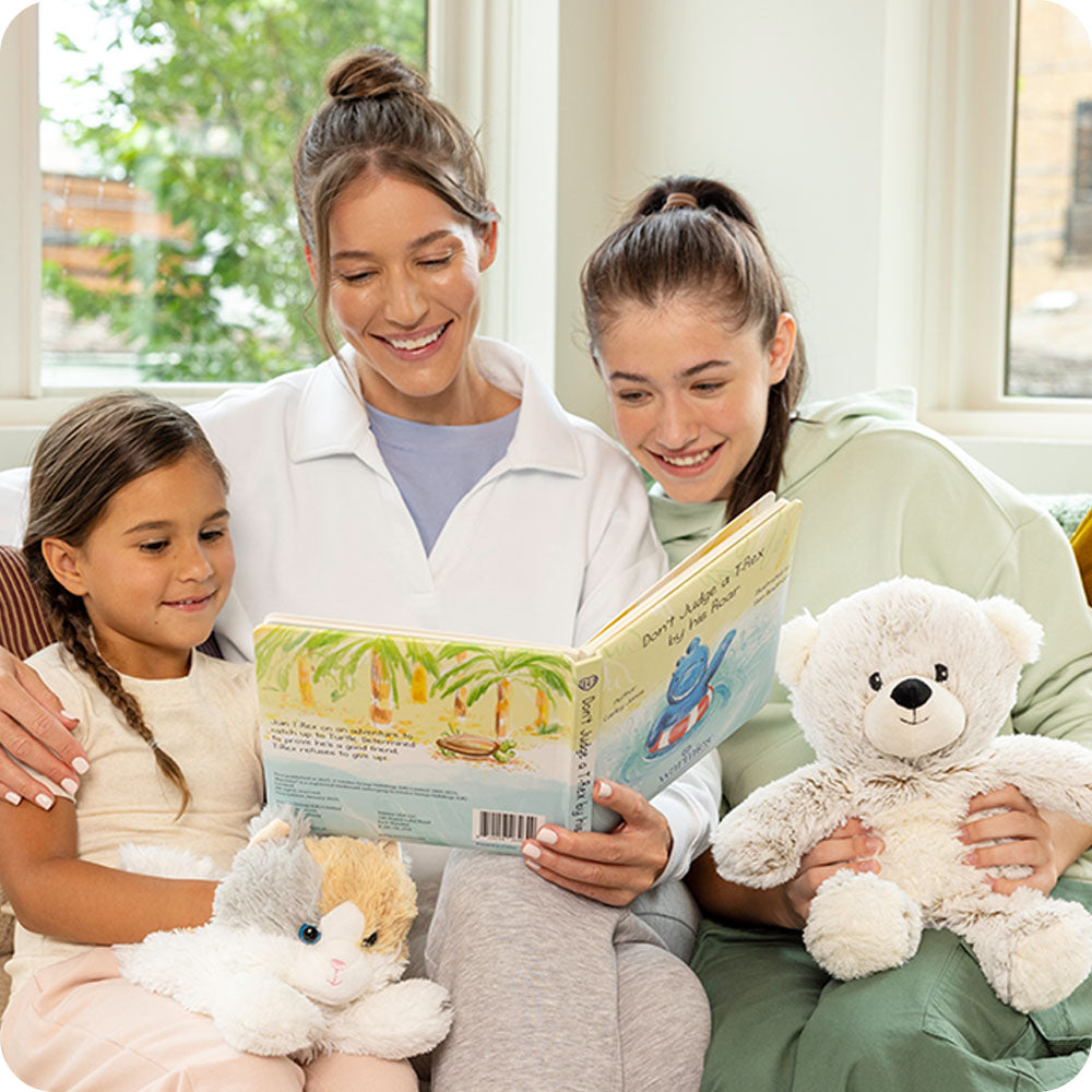 family reading Don't Judge a TRex by his Roar warmies book