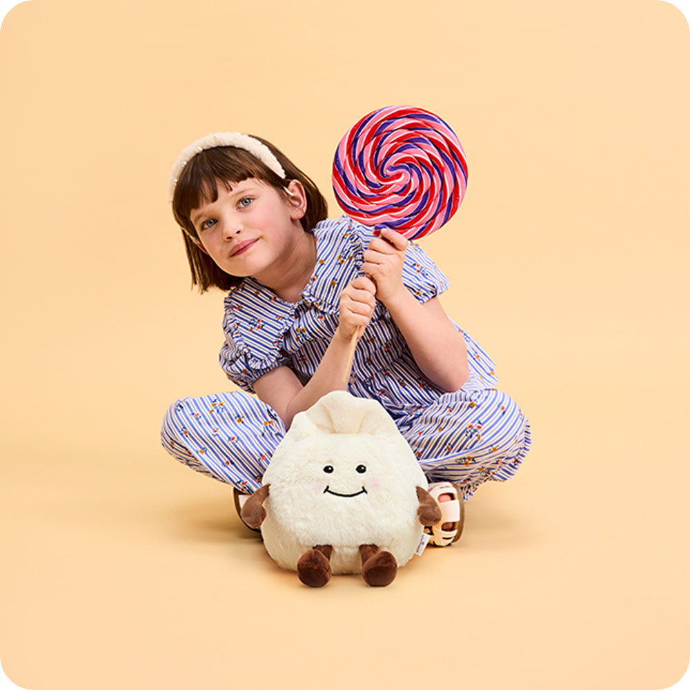 girl with dumpling stuffed animal at her feet