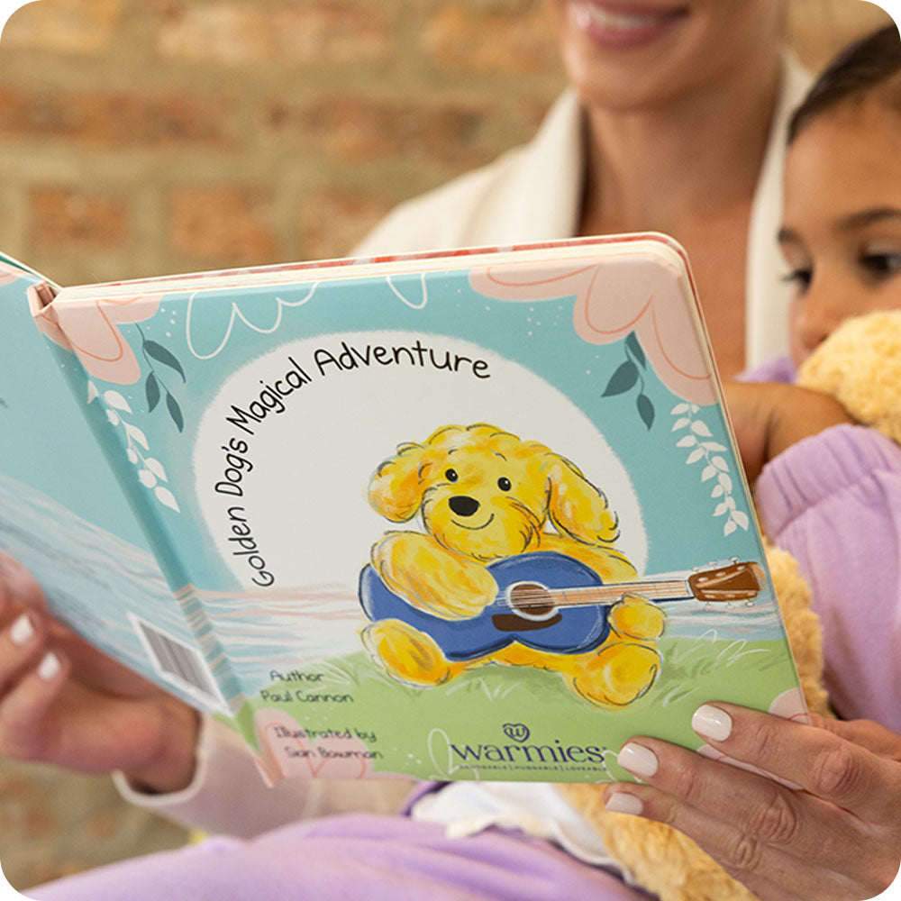 little girl and mom reading Golden Dog's Magical Adventure warmies book