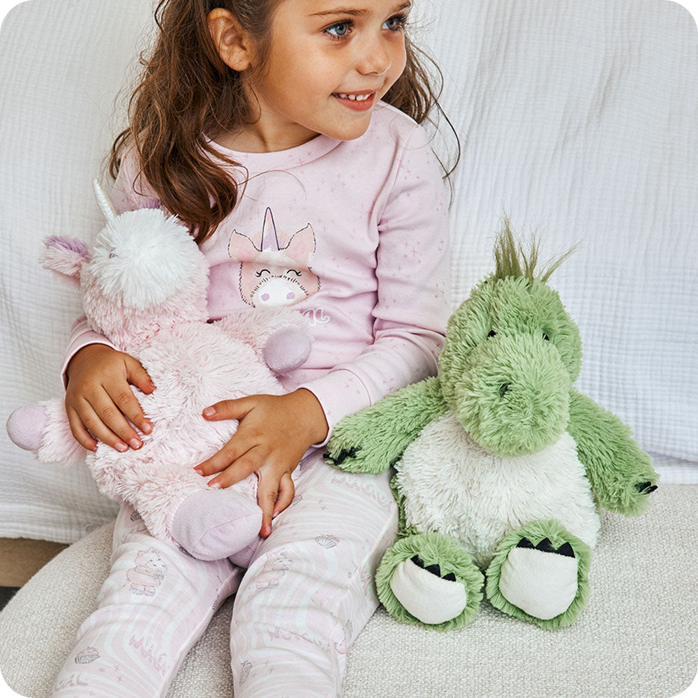 green dinosaur warmies stuffed animal on couch