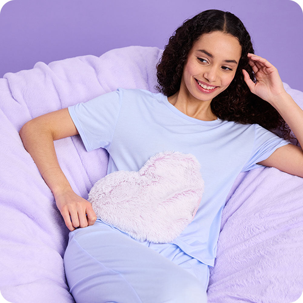 girl relaxing with lavender heart warmies
