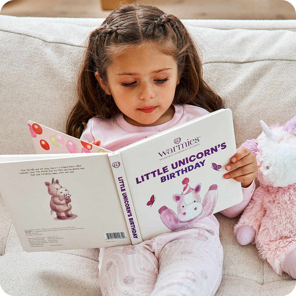 toddler reading warmies Little Unicorn's Birthday book