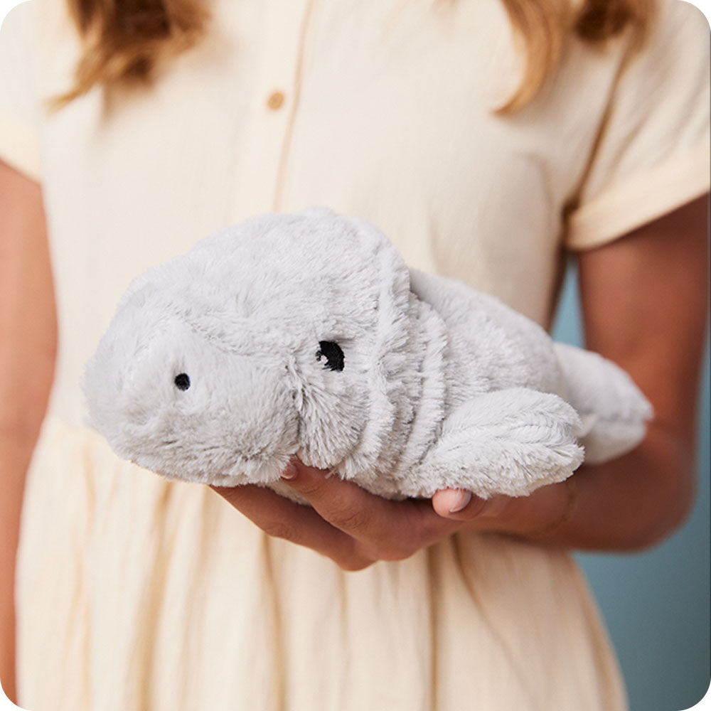 girl holding manatee stuffed animal