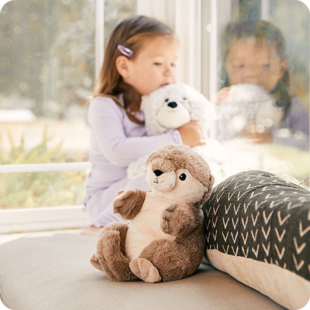 otter stuffed animal sitting on couch