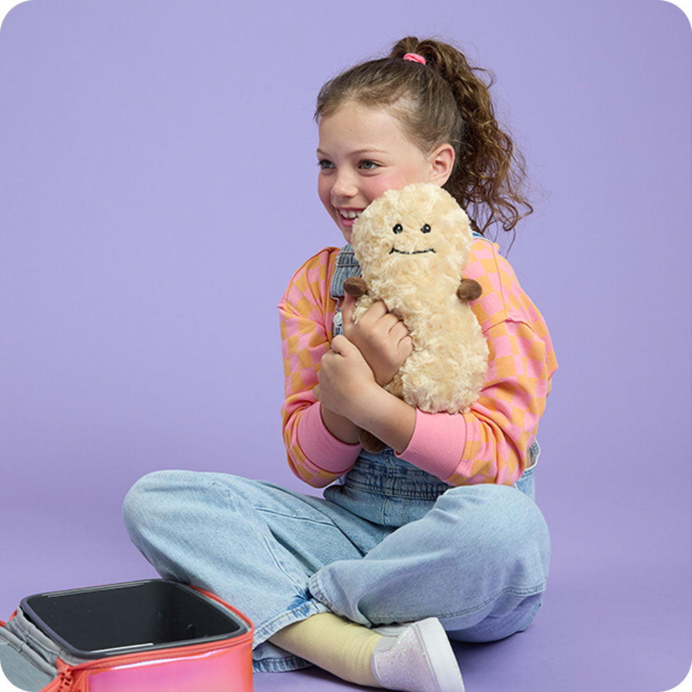 girl hugging peanut stuffed animal warmies