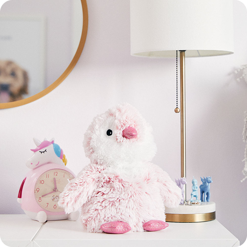 pink penguin stuffed animal on kids dresser