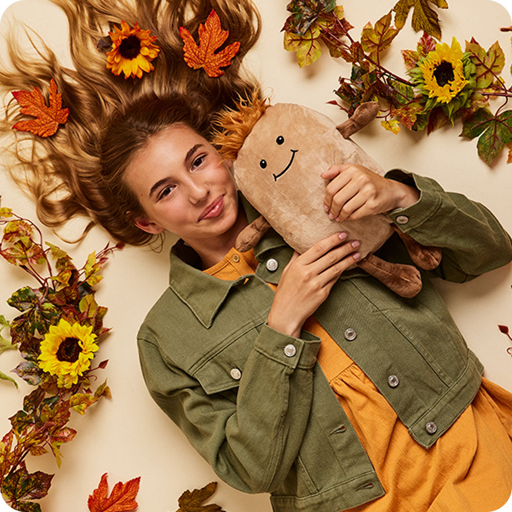 girl holding potato stuffed animal warmies