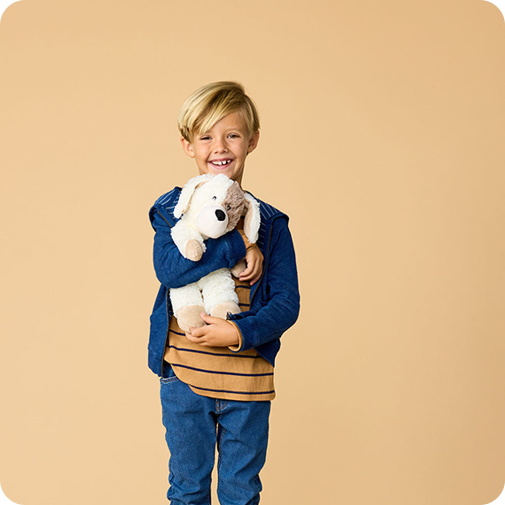 boy holding puppy stuffed animal