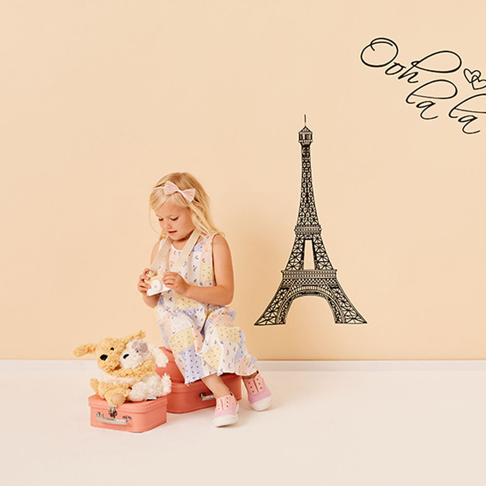 girl playing with puppy hugs stuffed animal warmies