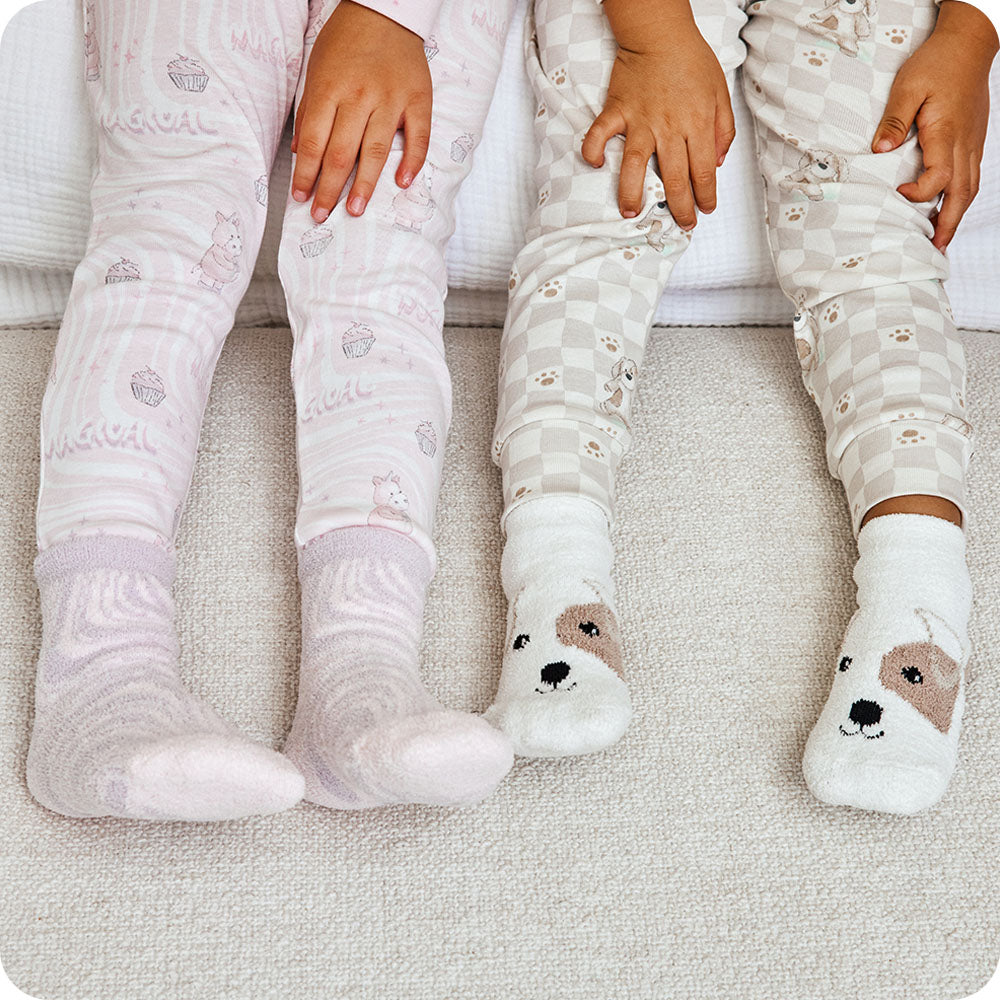 two kids wearing warmies unicorn and puppy socks