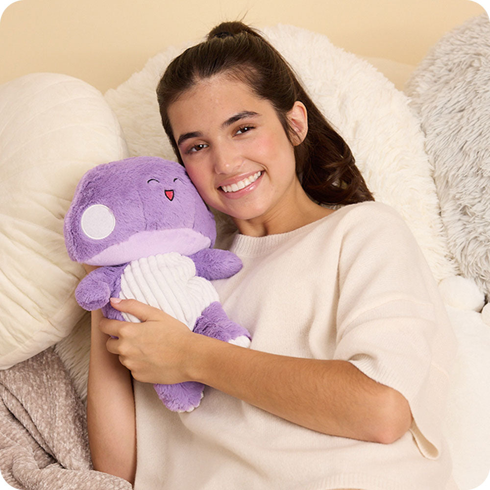 girl hugging purple mushroom stuffed animal warmies