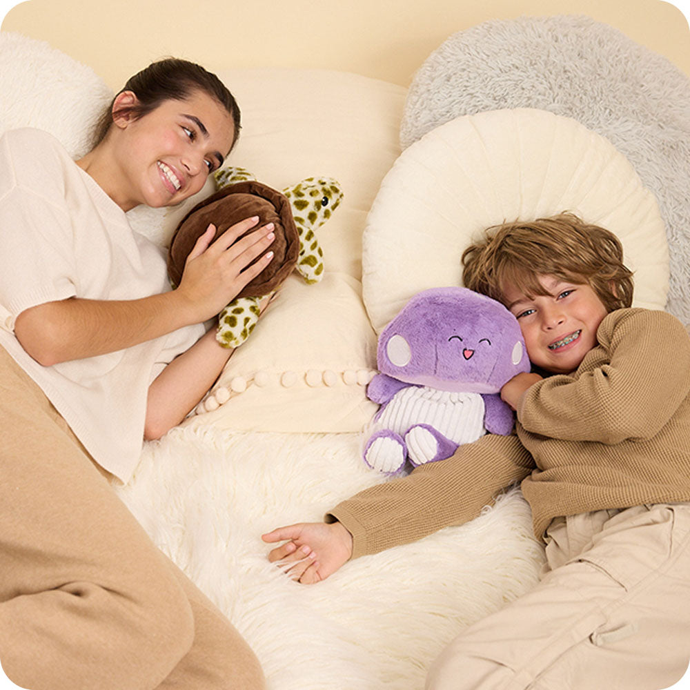 girl with turtle stuffed animal and boy with purple mushroom stuffed animal