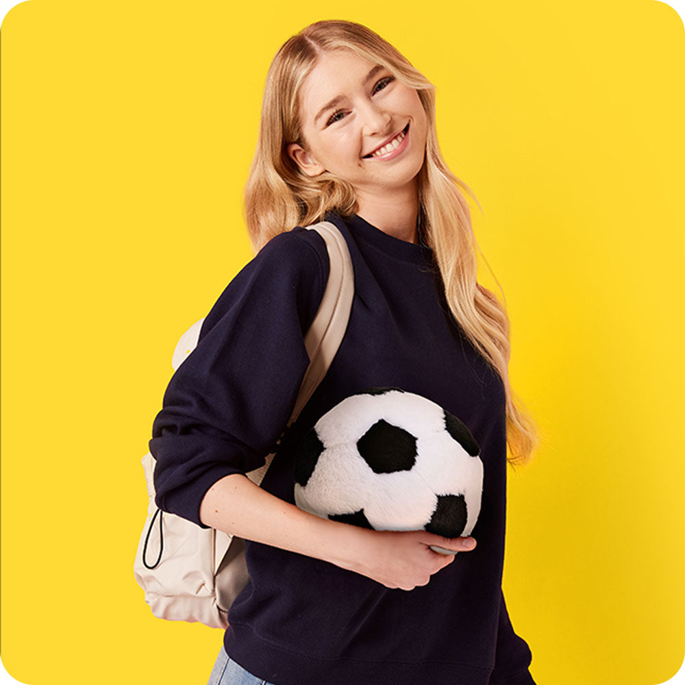 girl holding soccer ball stuffed animal warmies