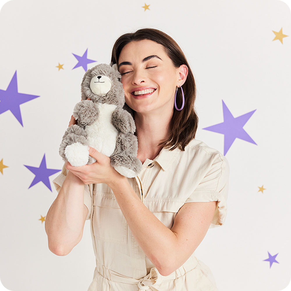 woman cuddling squirrel stuffed animal warmies