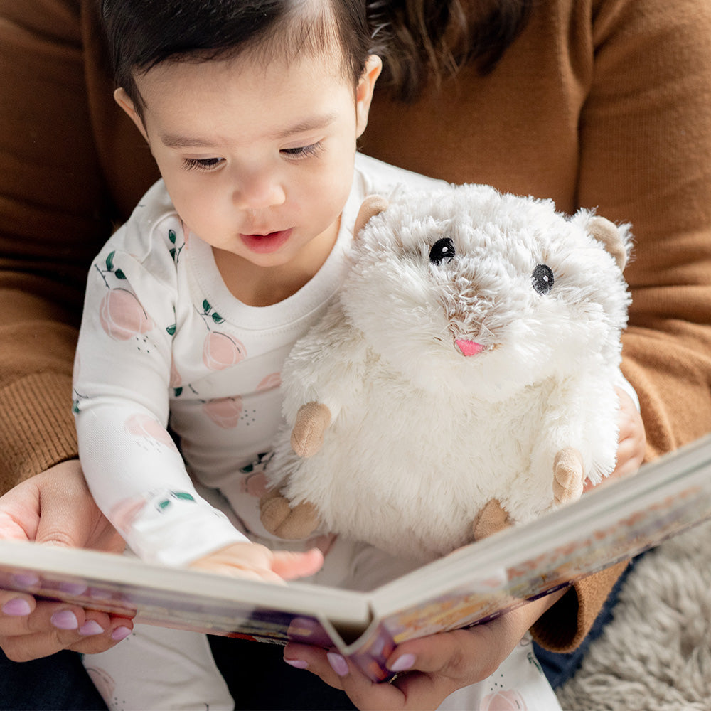 Mom and baby boy reading book with Cute Weighted Lavender Scented Hamster Stuffed Animal Heating Pad Warmies