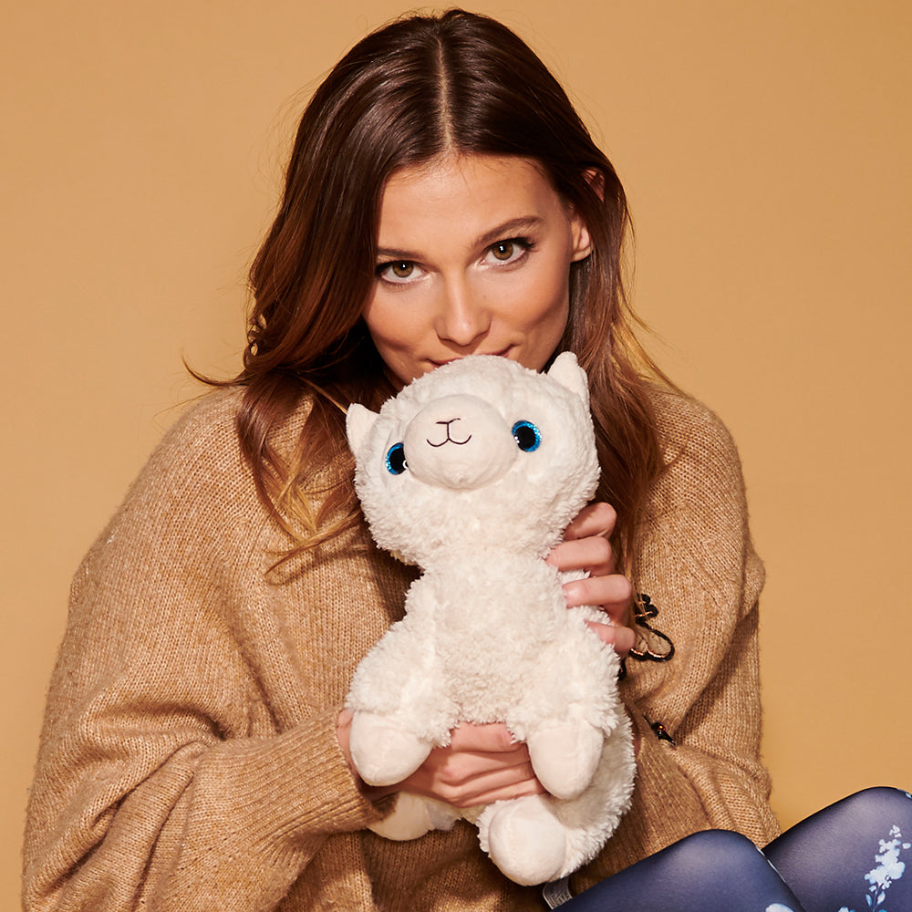 Woman holding Cute Weighted Lavender Scented Llama Stuffed Animal Heating Pad Warmies