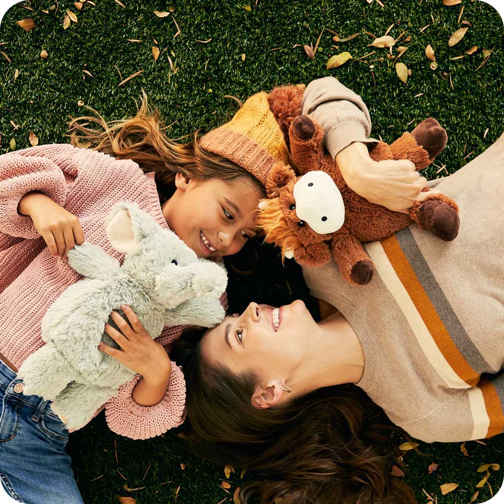 Mom and daughter smiling with Cute Weighted Lavender Scented Gray Elephant Stuffed Animal Heating Pad Warmies