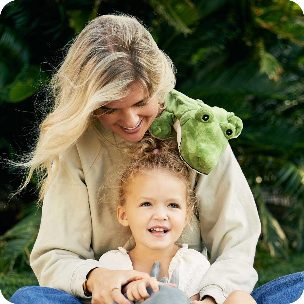 Mother and Daughter play with a Cute Weighted Lavender Scented Alligator Stuffed Animal Heating Pad Warmies