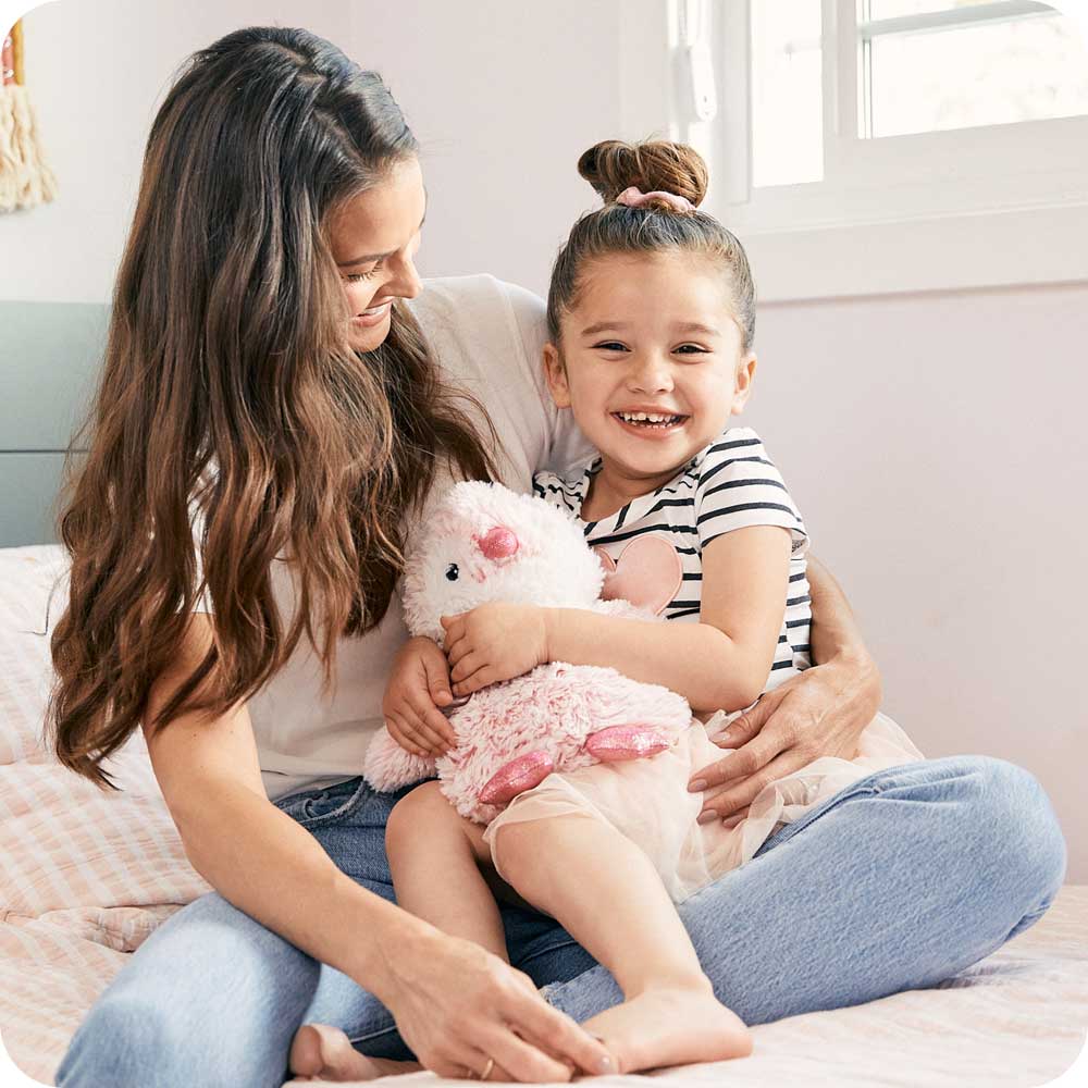 Mother and daughter holding Cute Weighted Lavender Scented Pink Penguin Stuffed Animal Heating Pad Warmies