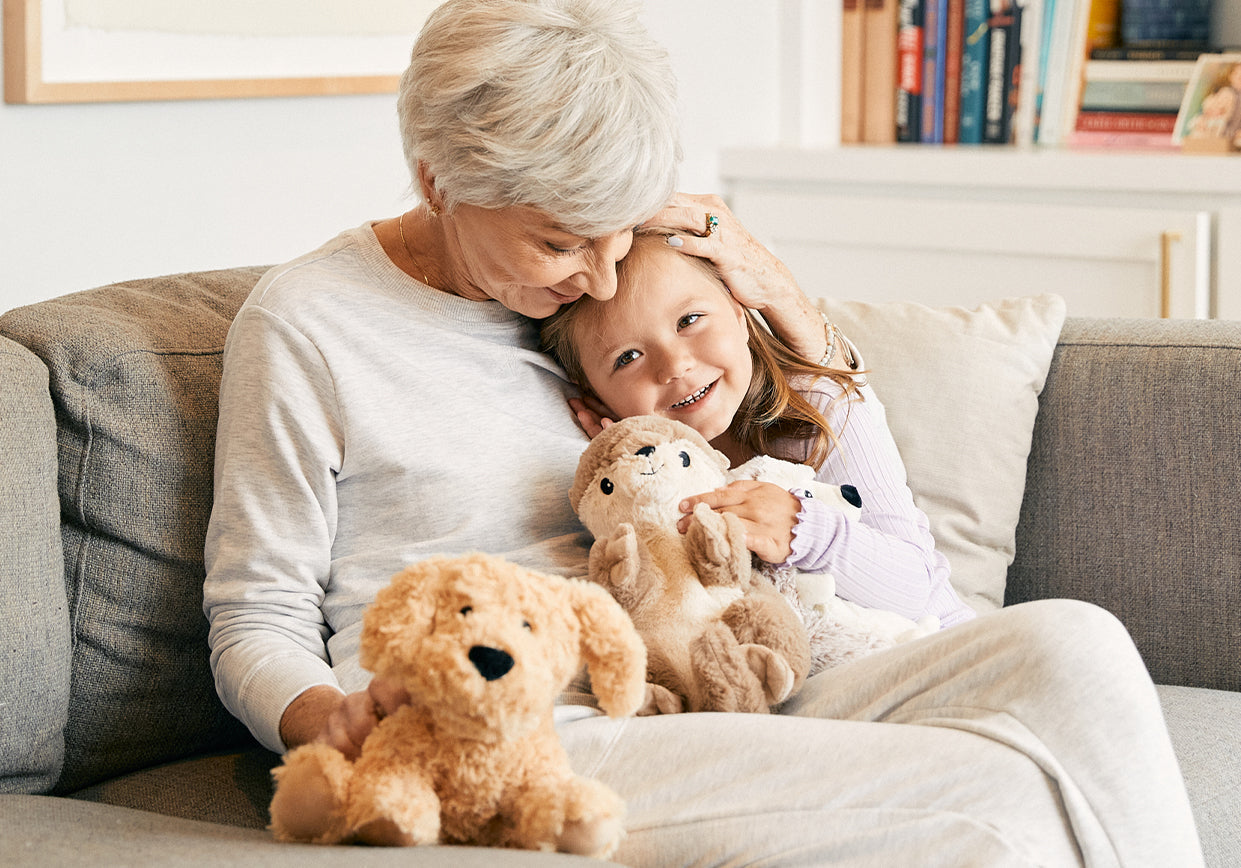A grandma with her granddaughter and their Warmies.