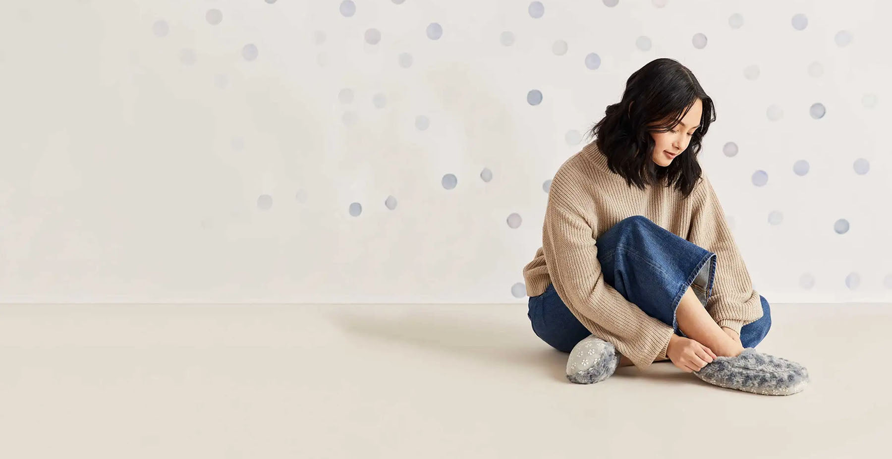 woman wearing grey warmies warming slippers