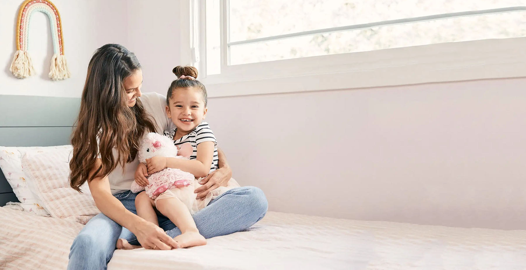 mom and daughter playing with pink penguin stuffed animal warmies