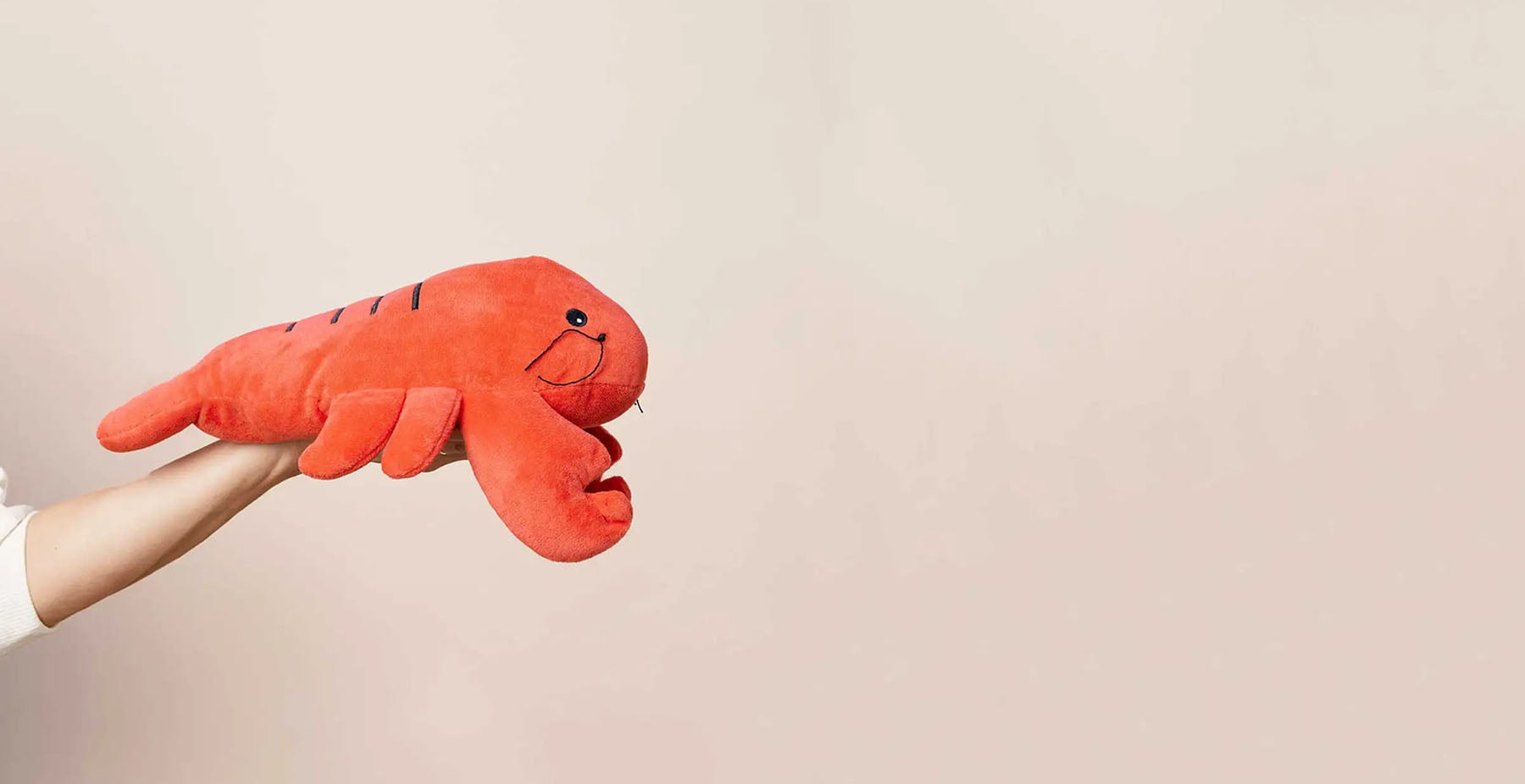 hand presenting a lobster stuffed animal