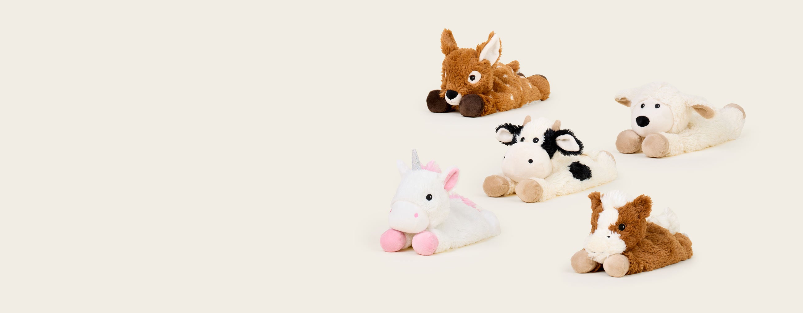 Deer, Cow, and Horse Laying Down Warmies sitting in a group.