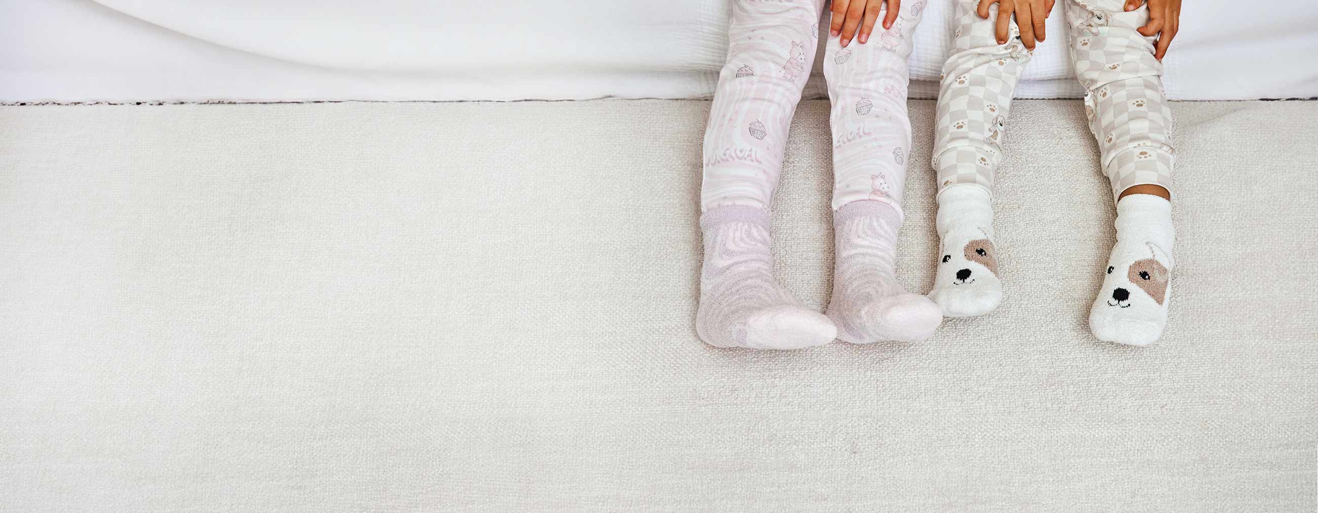 Children wearing Warmies Unicorn Crew socks and Warmies Puppy Crew Socks.