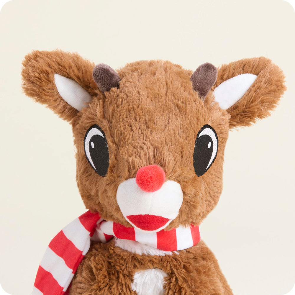Plush reindeer toy with a red nose and striped scarf on a light background