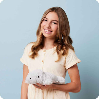 Teen holding Soft Warm Weighted Manatee Plush Warmies